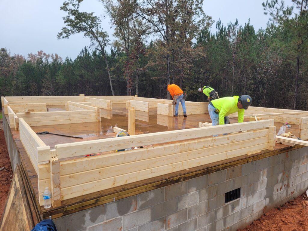 Assembly crew working on a premanufactured building, one row at a time.