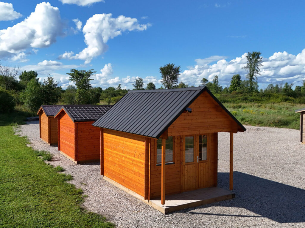 A row of small buildings on a lot.