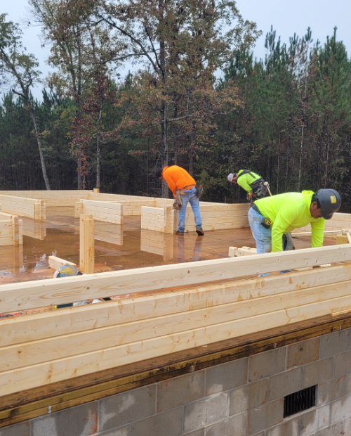 A 3 person crew assembling a premanufactured building.