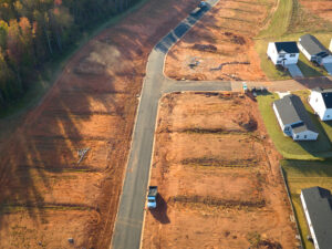 A series of open lots on both sides of a road.